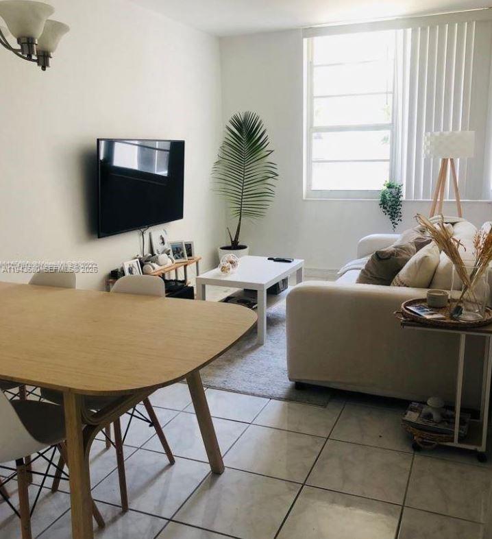 100 Lincoln Road, Unit 524 Miami Beach, FL 33139 - Photo 1 of 3 a living room with furniture and a flat screen tv