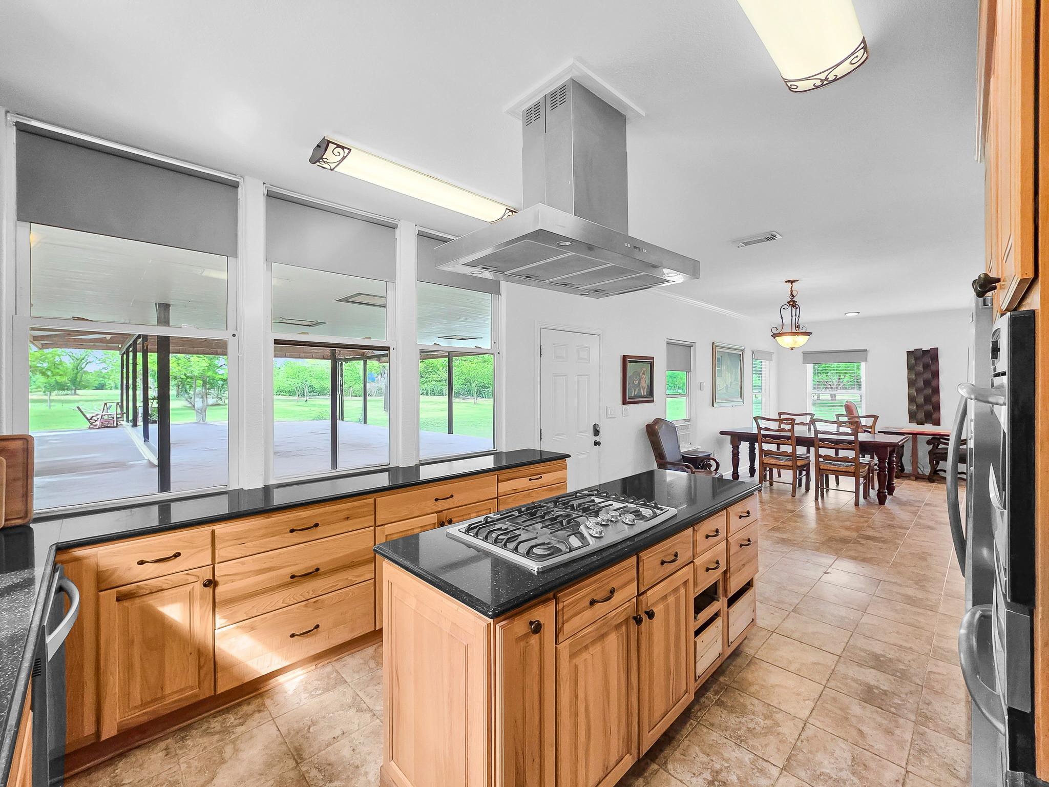 1771 Wilpitz Road Brookshire, TX 77423 - Photo 18 of 50 a kitchen with stainless steel appliances granite countertop a stove and a dining table
