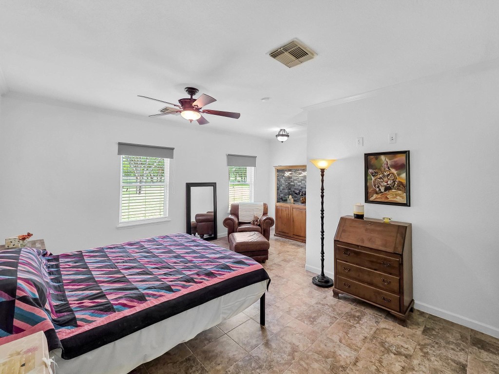 1771 Wilpitz Road Brookshire, TX 77423 - Photo 20 of 50 a bedroom with a bed and a chandelier