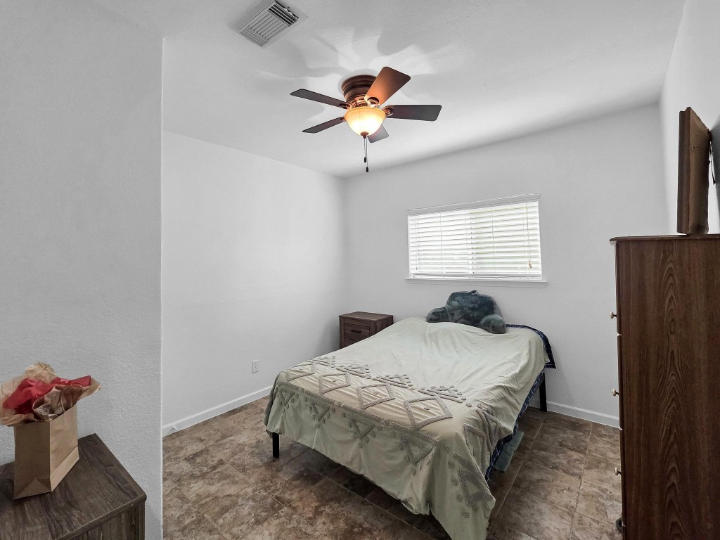 1771 Wilpitz Road Brookshire, TX 77423 - Photo 28 of 50 a bedroom with a bed and a chandelier