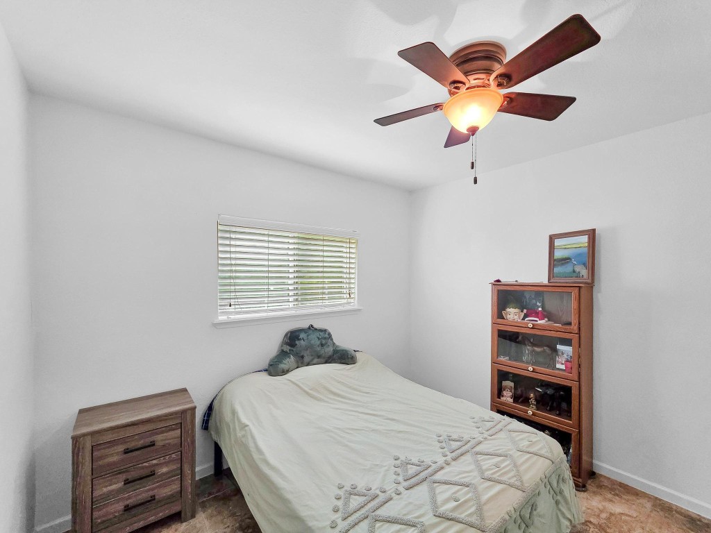 1771 Wilpitz Road Brookshire, TX 77423 - Photo 29 of 50 a bedroom with a bed and a chandelier