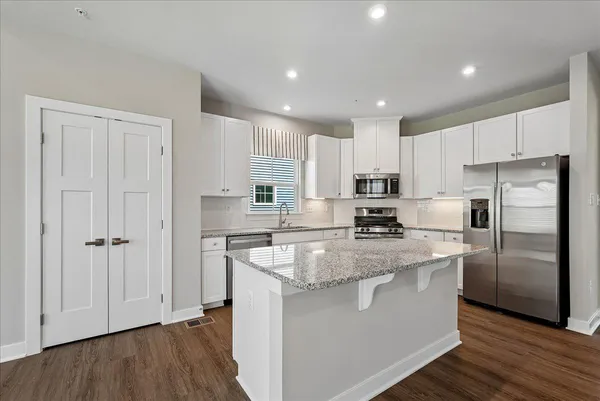 a view of kitchen with furniture and wooden floor