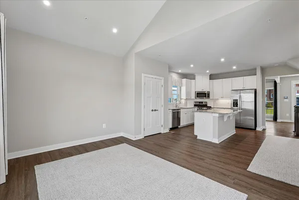 a view of a kitchen with a sink and stainless steel appliances