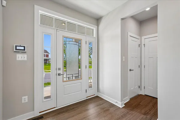 a view of an entryway with wooden floor
