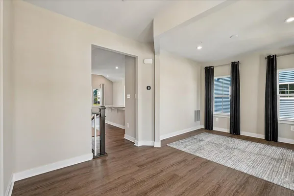 a view of a bedroom with window and wooden floor