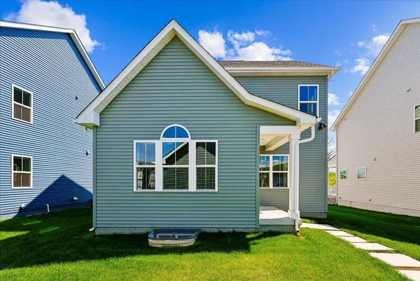 a front view of house with yard and garage