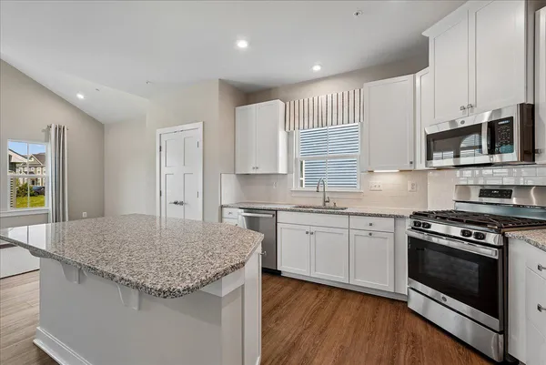 a kitchen with a sink stove and refrigerator