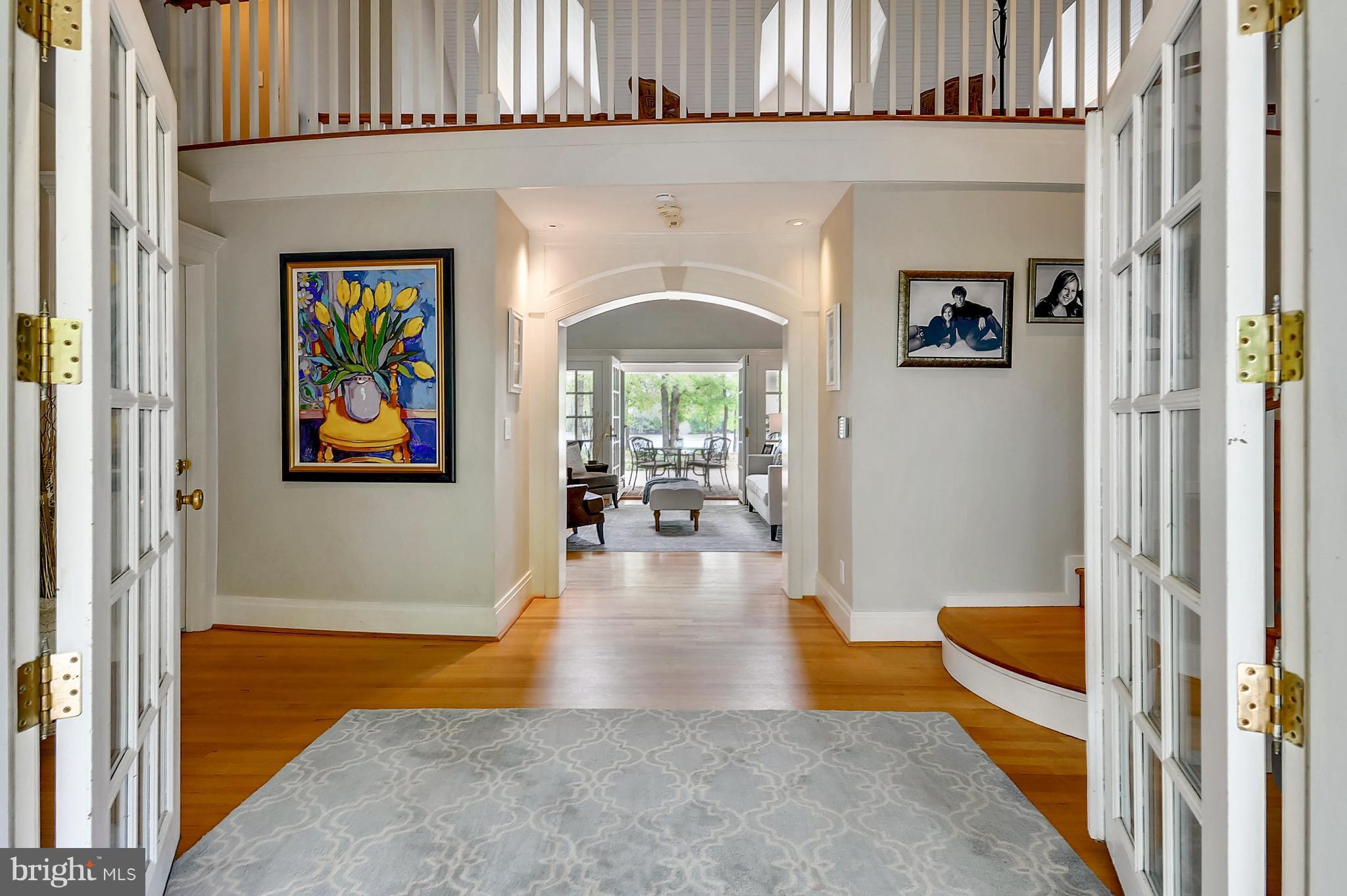 700 Seagull Beach Road Prince Frederick, MD 20678 - Photo 2 of 30 a view of a hallway with wooden floor and a dining table