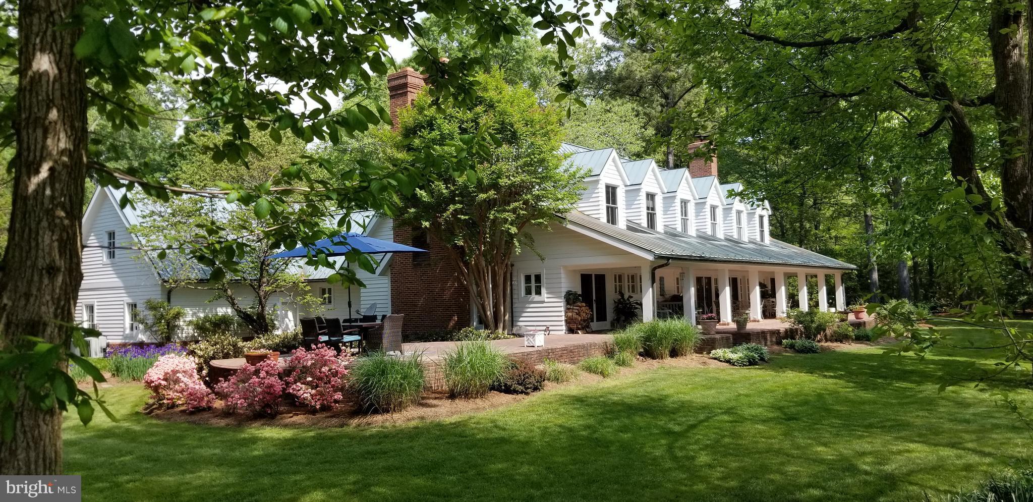 700 Seagull Beach Road Prince Frederick, MD 20678 - Photo 11 of 30 a front view of a house with a garden and plants