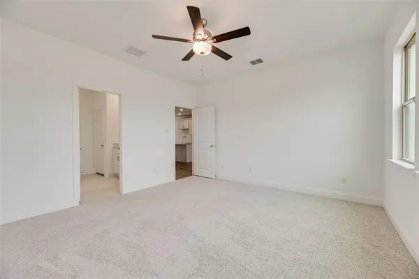 an empty room with closet and windows