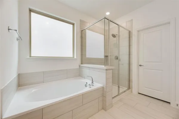 a white bath tub sitting next to a shower