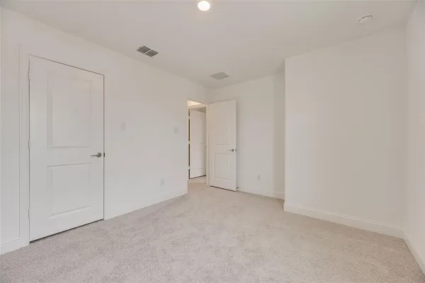a view of a green field with a wrought fence