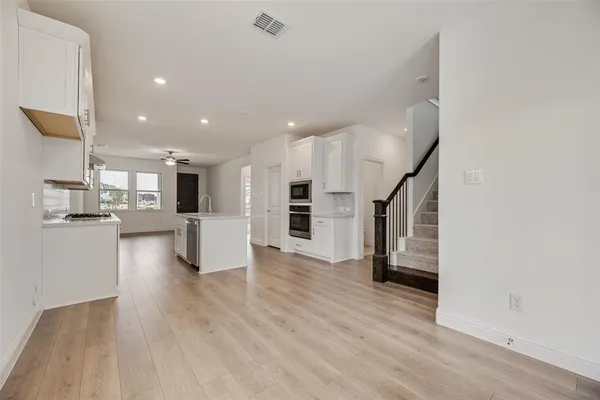 a view of a kitchen with wooden floor and a kitchen