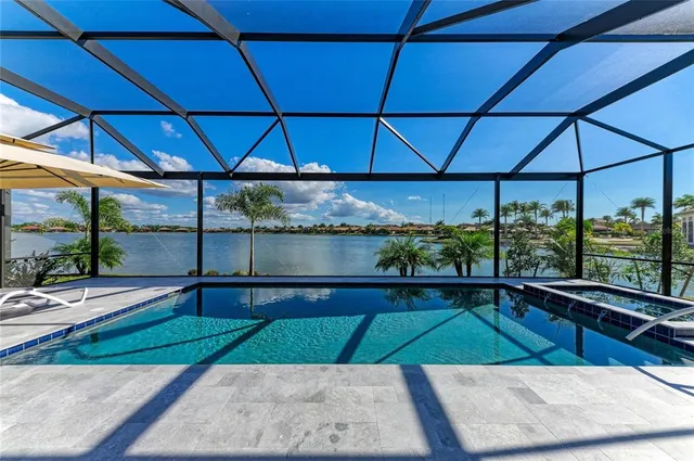 a large kitchen with kitchen island a dining table chairs and white cabinets