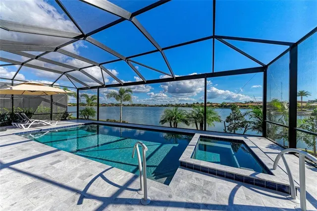 a kitchen with kitchen island a stove a refrigerator a sink a dining table and chairs