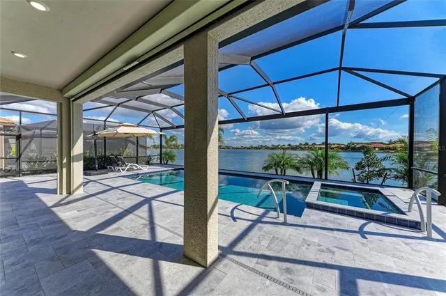 a kitchen with stainless steel appliances granite countertop white cabinets a stove top oven and granite counter tops