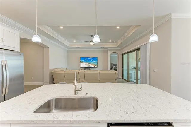 a bathroom with a granite countertop sink a toilet and shower