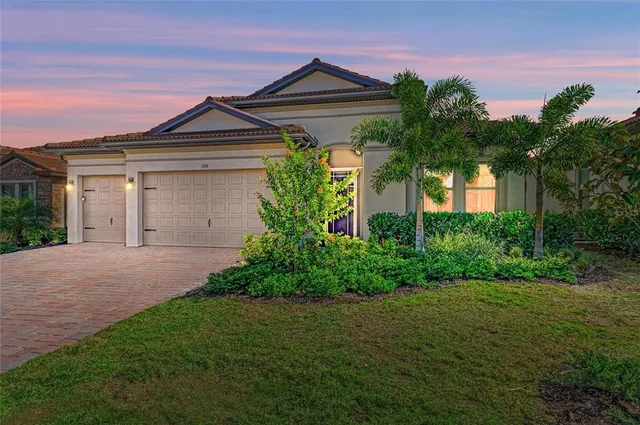 a front view of a house with a garden and plants