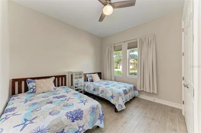 a living room with pool table flat screen tv and a chandelier