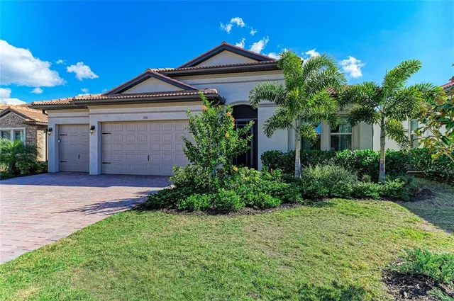 a front view of a house with a yard and garage