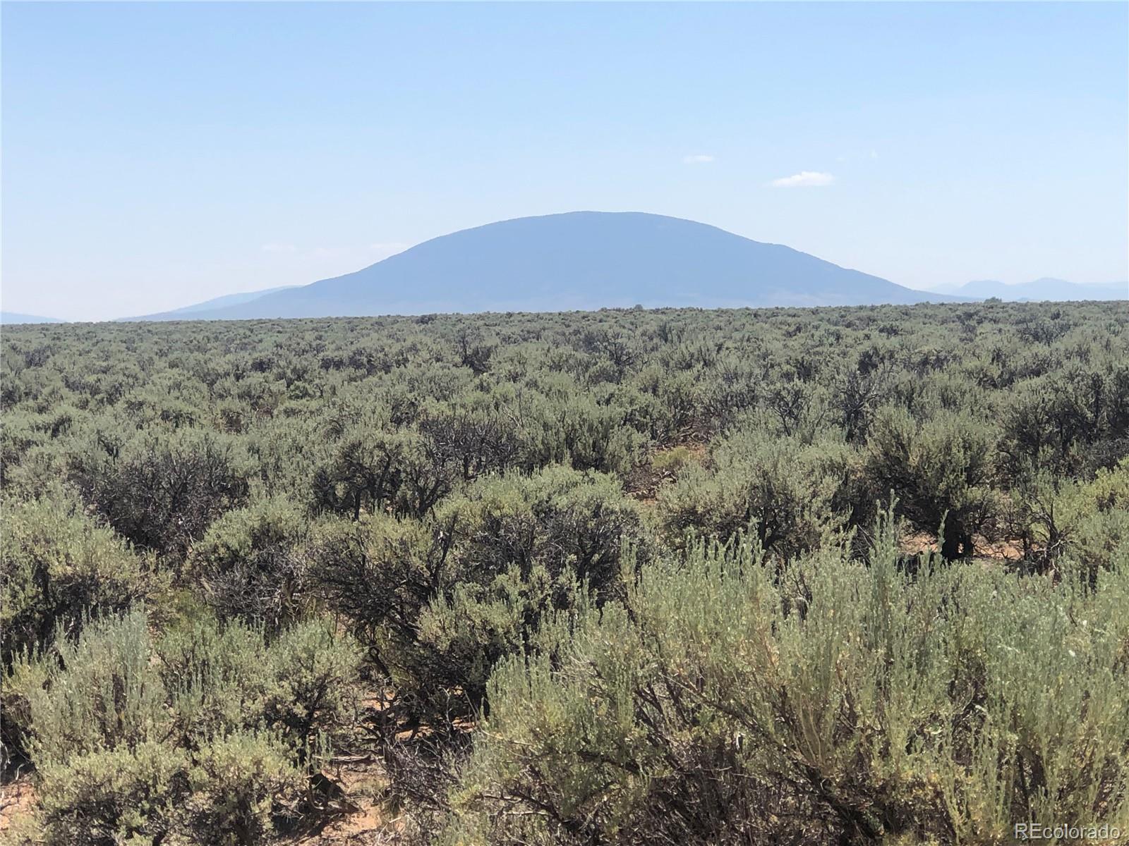 0 County Rd J San Luis, CO 81152 - Photo 1 of 8 a view of a field with trees in background