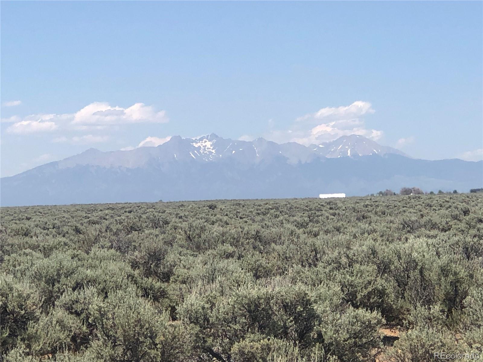 0 County Rd J San Luis, CO 81152 - Photo 2 of 8 a view of a dry yard with mountains in the background