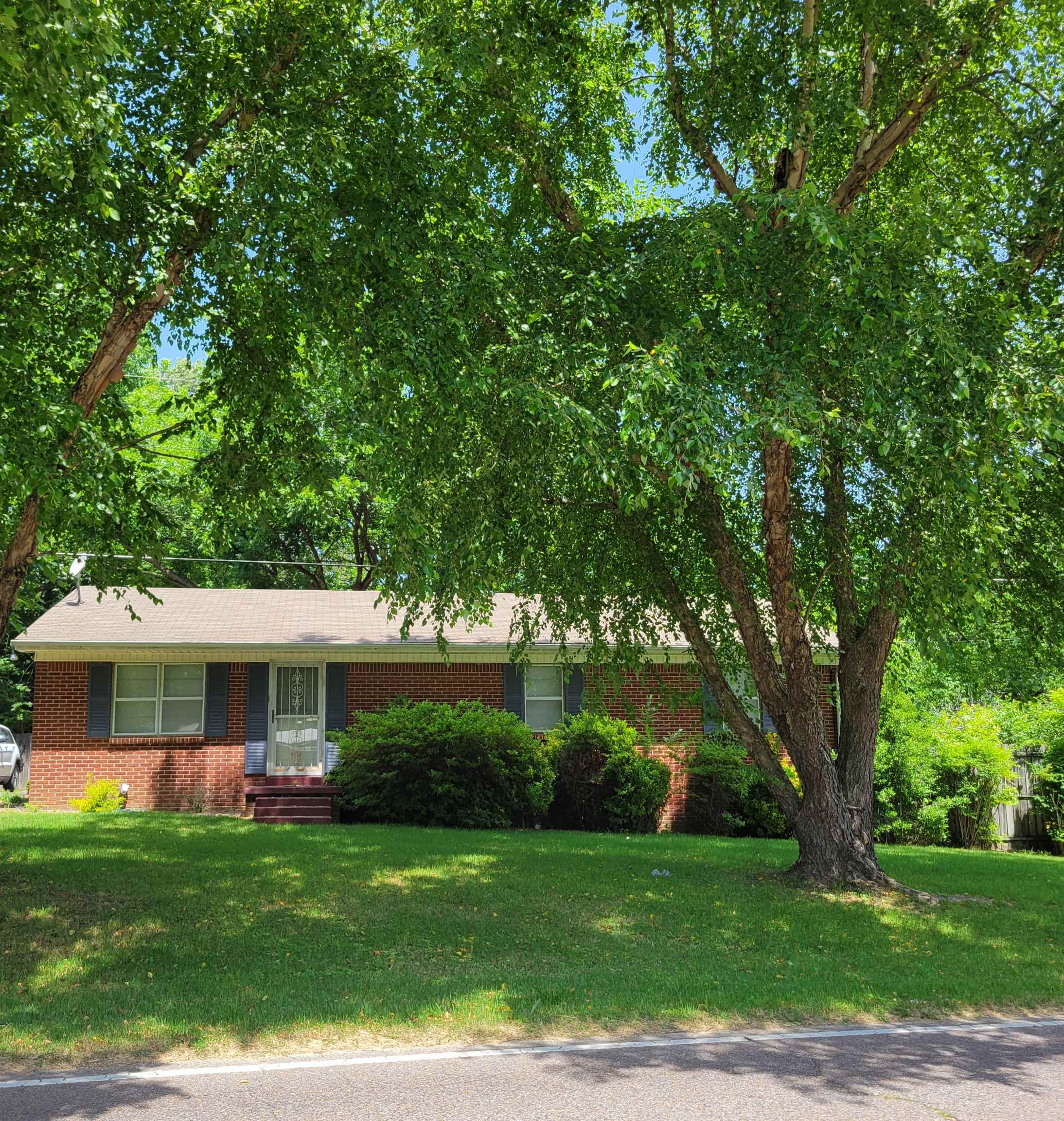 1572 Asbury Glimp Road Ripley, TN 38063 - Photo 1 of 20 a front view of a house with a garden