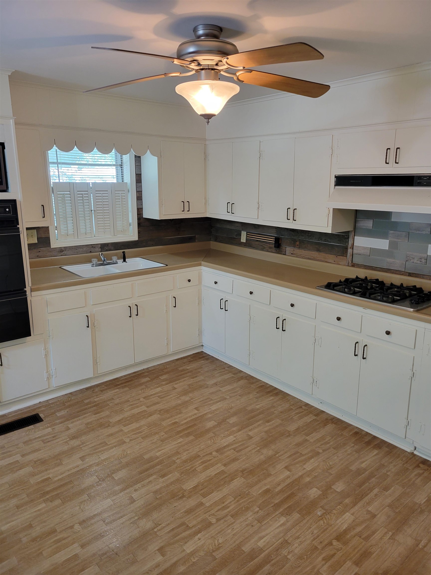 1572 Asbury Glimp Road Ripley, TN 38063 - Photo 11 of 20 a kitchen with granite countertop white cabinets and a sink