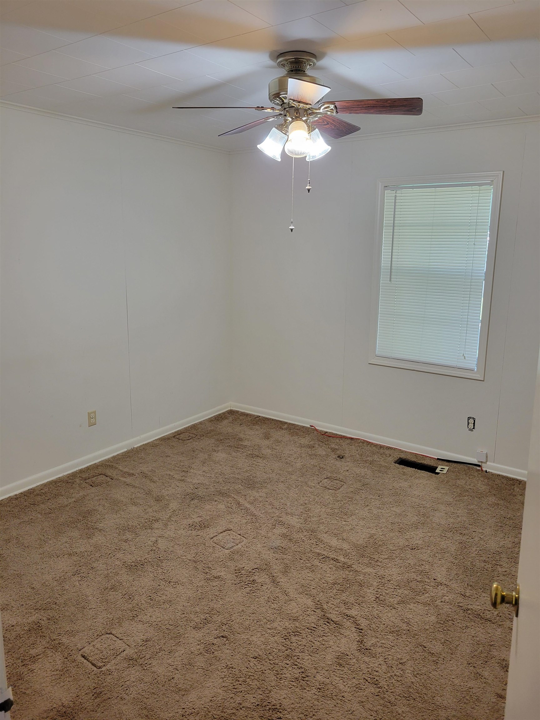 1572 Asbury Glimp Road Ripley, TN 38063 - Photo 20 of 20 an empty room with a chandelier fan and windows