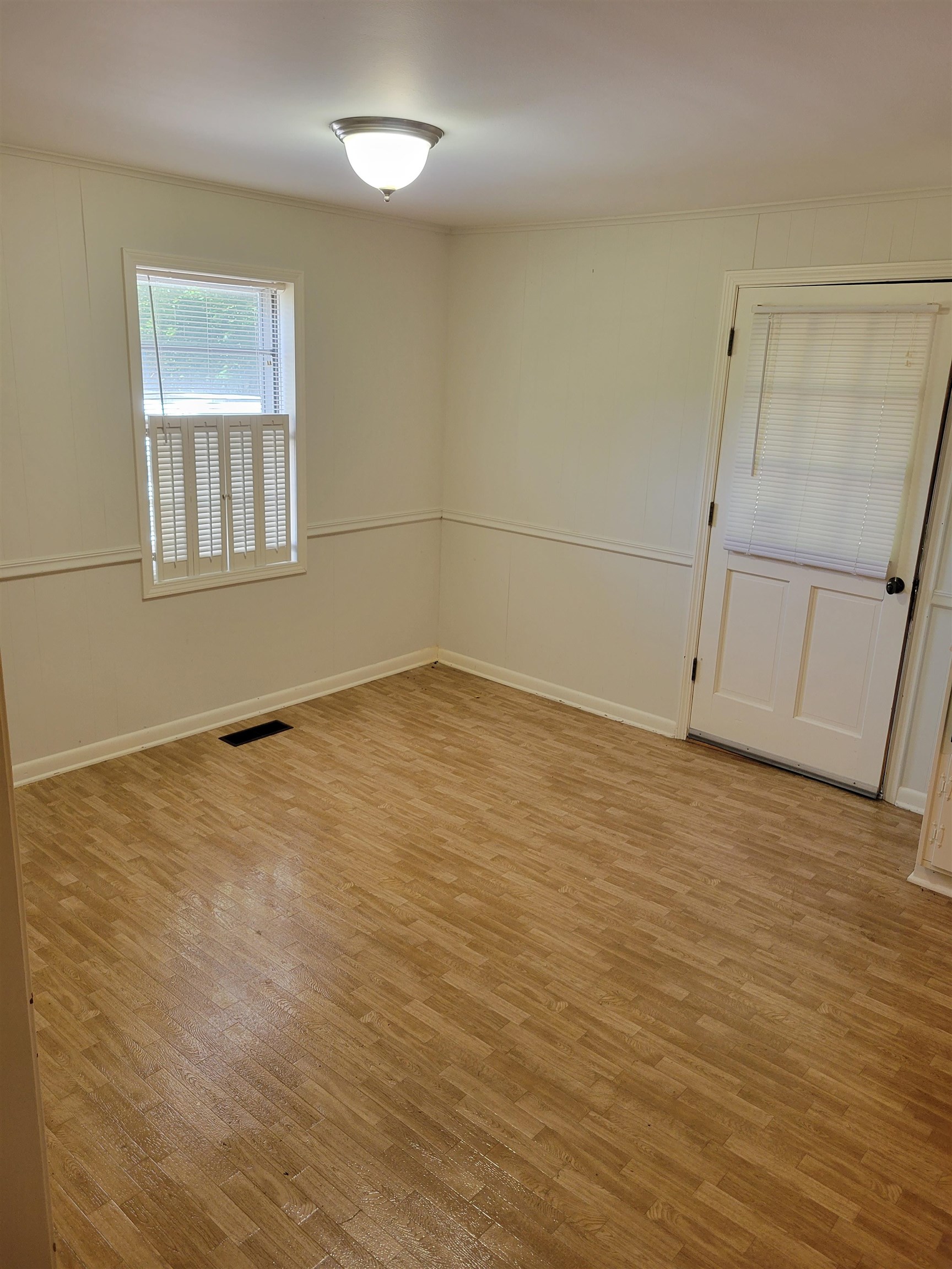 1572 Asbury Glimp Road Ripley, TN 38063 - Photo 9 of 20 wooden floor in an empty room with a window