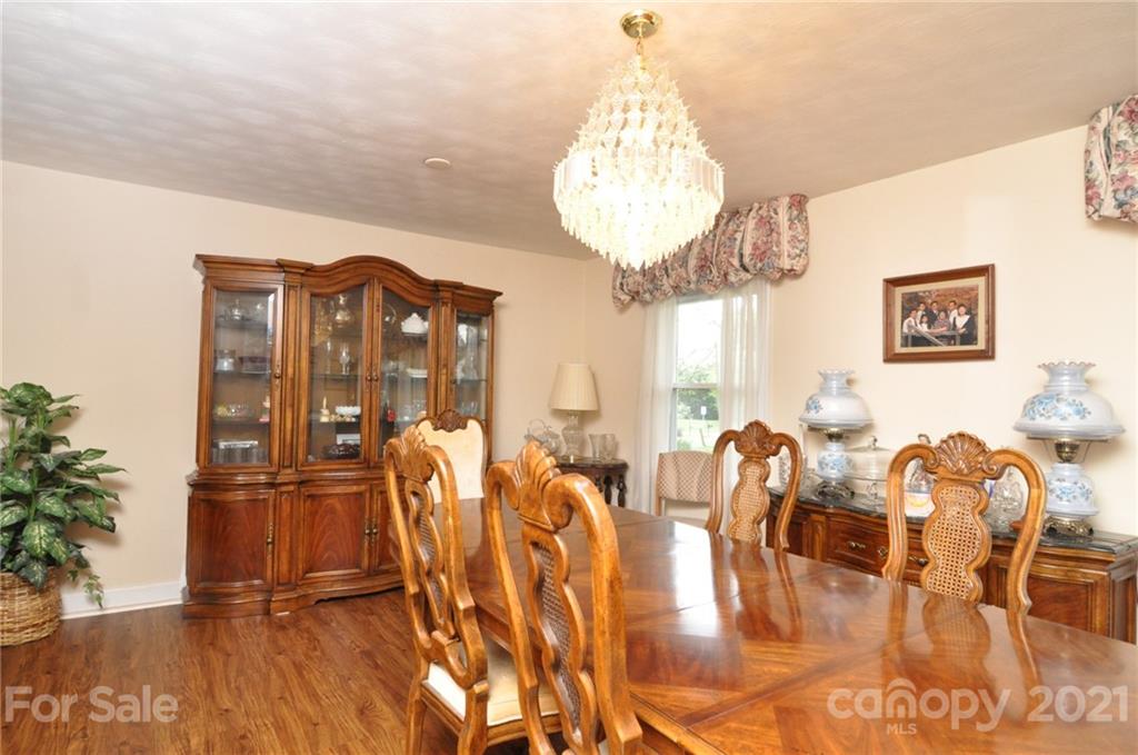 501 Redland Road Landrum, SC 29356 - Photo 13 of 38 a view of a dining room with furniture and chandelier