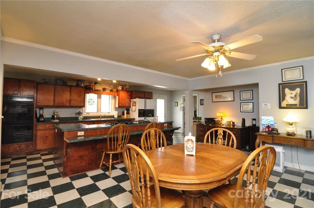 501 Redland Road Landrum, SC 29356 - Photo 17 of 38 a dining hall with stainless steel appliances a dining table and chairs