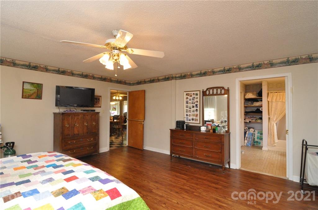 501 Redland Road Landrum, SC 29356 - Photo 24 of 38 a bedroom with a bed and a flat screen tv