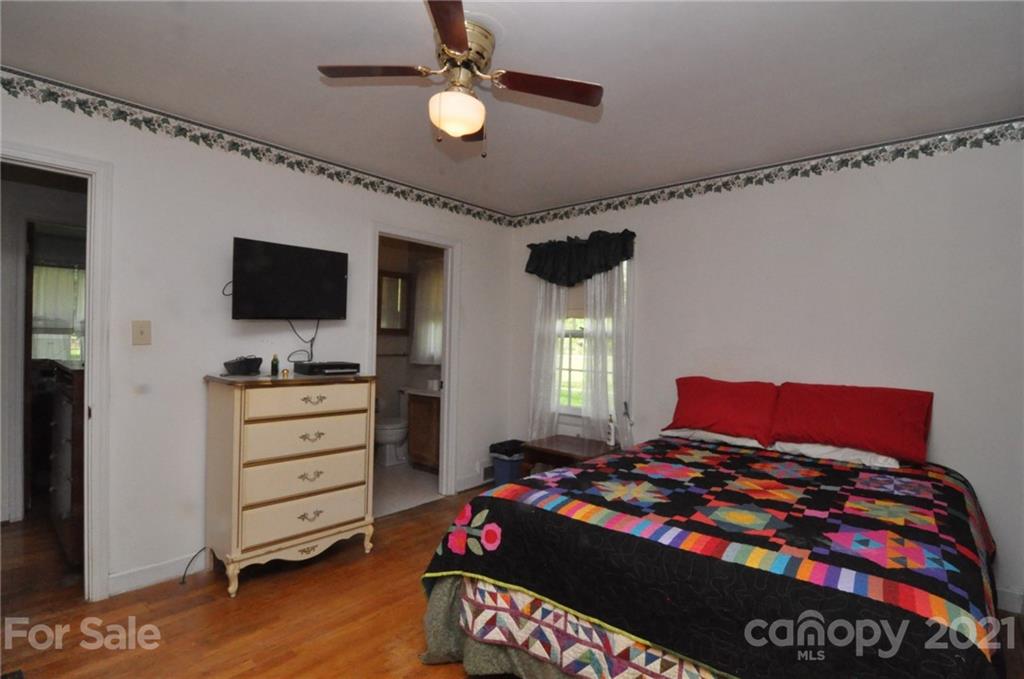 501 Redland Road Landrum, SC 29356 - Photo 28 of 38 a bedroom with a bed and wooden floor