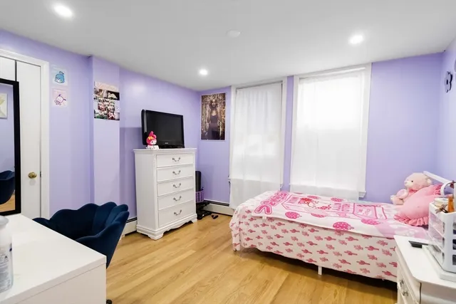 a bedroom with a bed and a flat tv screen