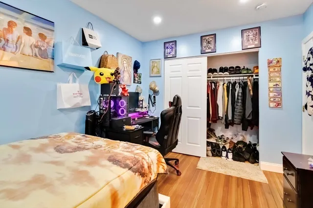 a bedroom with a bed and a view of kitchen