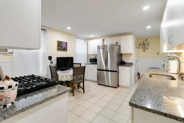 a kitchen with a refrigerator and a sink