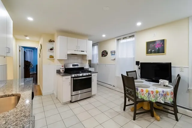 a kitchen with stainless steel appliances kitchen island granite countertop a sink and a refrigerator