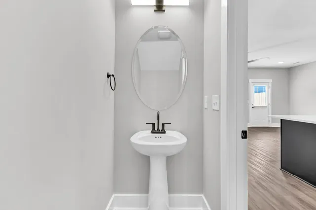 a bathroom with a sink a mirror and shower