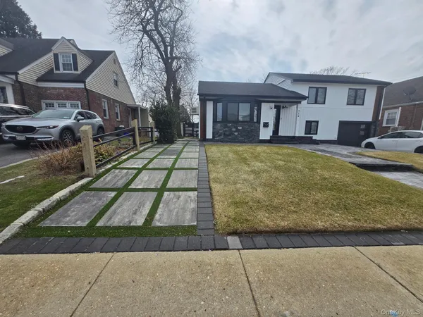 a front view of a house with garden