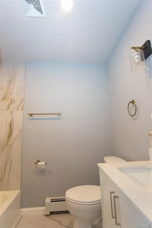 a bathroom with a toilet and a sink