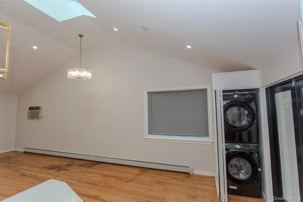 a view of a hallway with washer and dryer