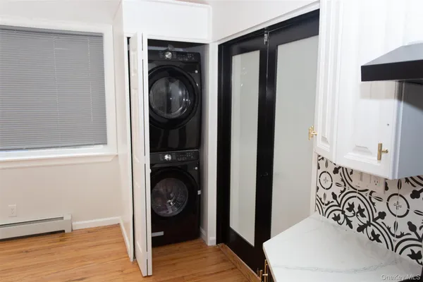 a view of a hallway with washer and dryer
