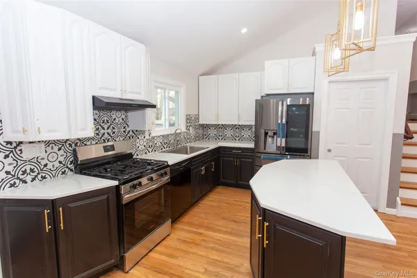 a kitchen with a sink a stove and refrigerator