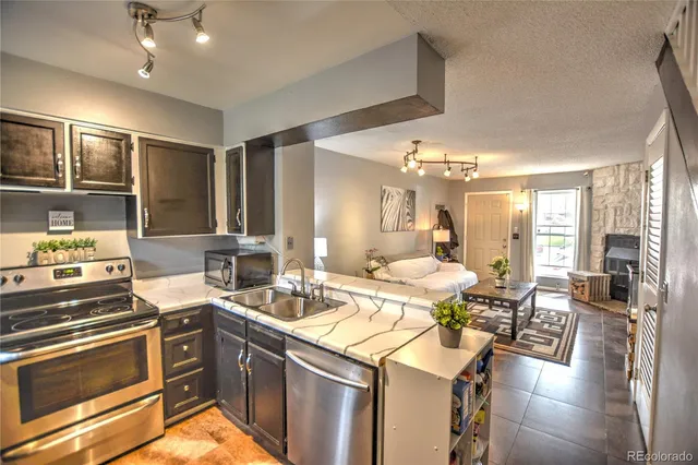 a kitchen with a sink appliances and cabinets