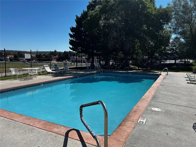 a view of a swimming pool with a table and chairs