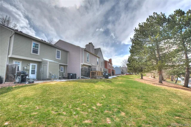 a house view with swimming pool in front of it