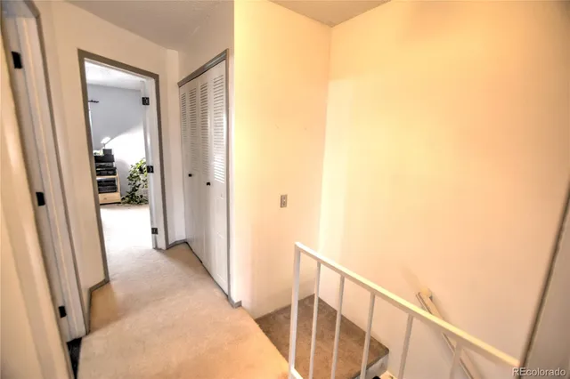 a view of a hallway with wooden floor and entryway