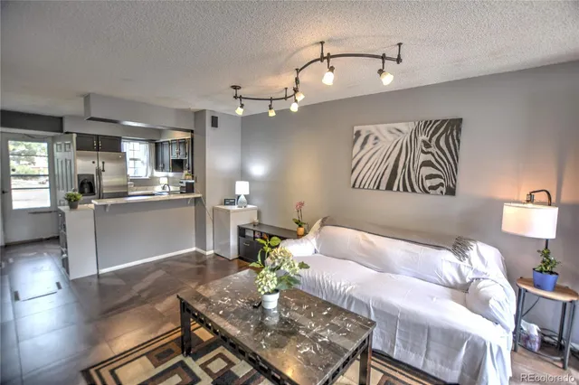 a living room with furniture and kitchen view