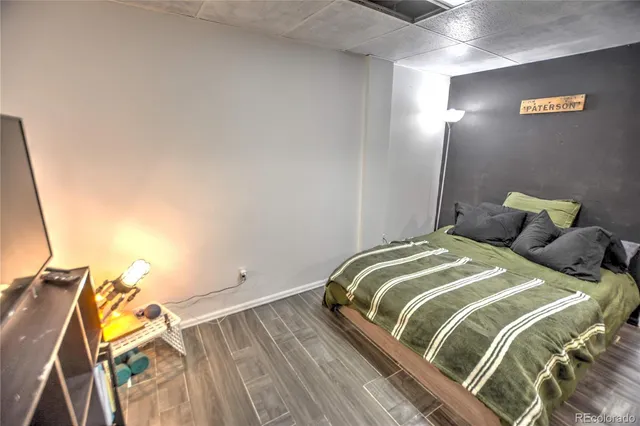 a bedroom with two beds and a wooden floor